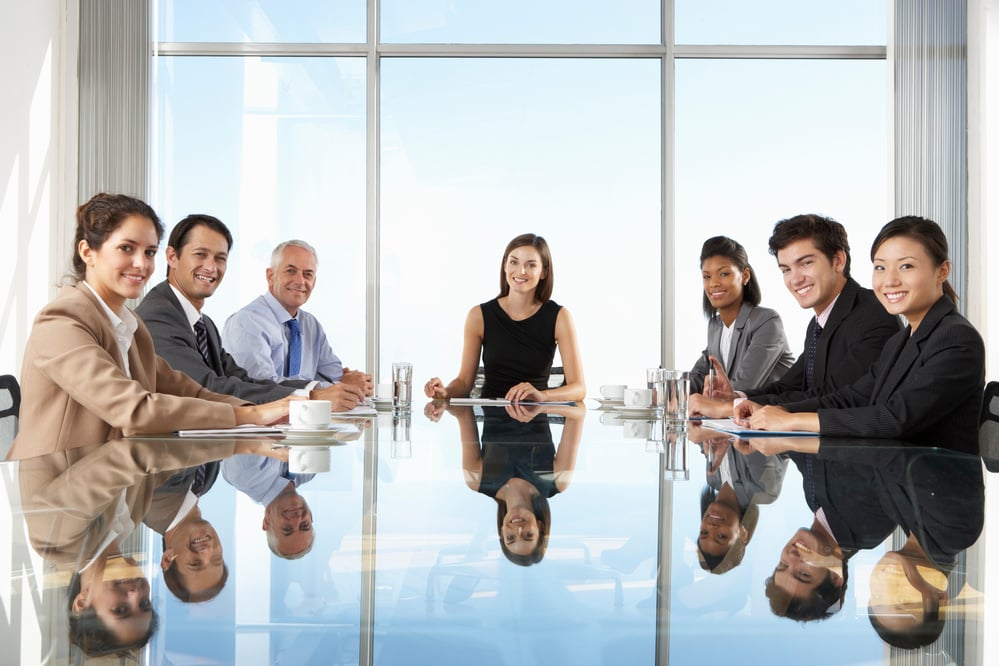 Group of Business People Having Board Meeting around Glass Table